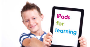 A child with disability holds an iPad