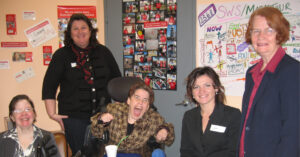 People with disability and Northcott staff smiling happily and showing their support for an NDIS