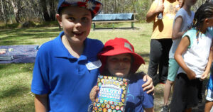 Sam and Ben Pitcher holding the Pokemon book they won for best team work.