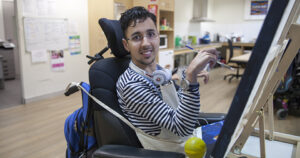 Parramatta Life Skills customer, Sharrief Elkanj painting a piece of artwork for the ART LIFE exhibition.
