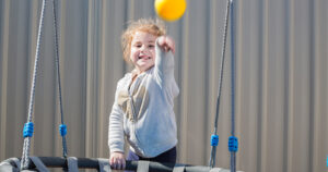 Early Childhood customer Maddison smiling and pointing