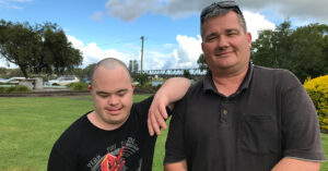 Support Worker Johan with Northcott customer Shane leaning on his arm