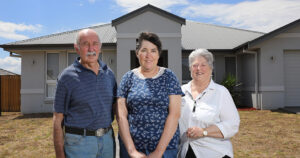 Diane stands out of the front of her new house with her parents John on the left and Jenny on the right.