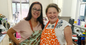 Smiling teen in the kitchen with her support worker