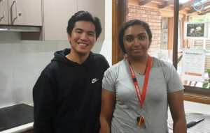 Young man and young woman smiling to the camera