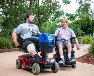 Two males in power wheelchairs