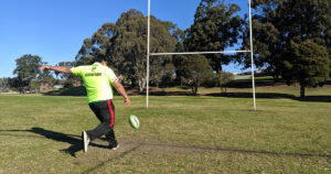 Sanil kicking football on football field