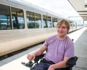 Customer in wheelchair infront of a train