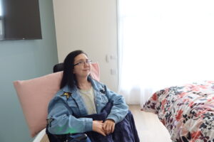 young woman in a wheelchair in her bedroom