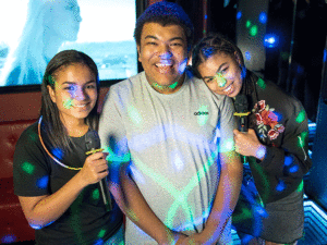 a group of teenagers at karaoke