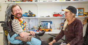 A man in a wheelchair in front of his lego
