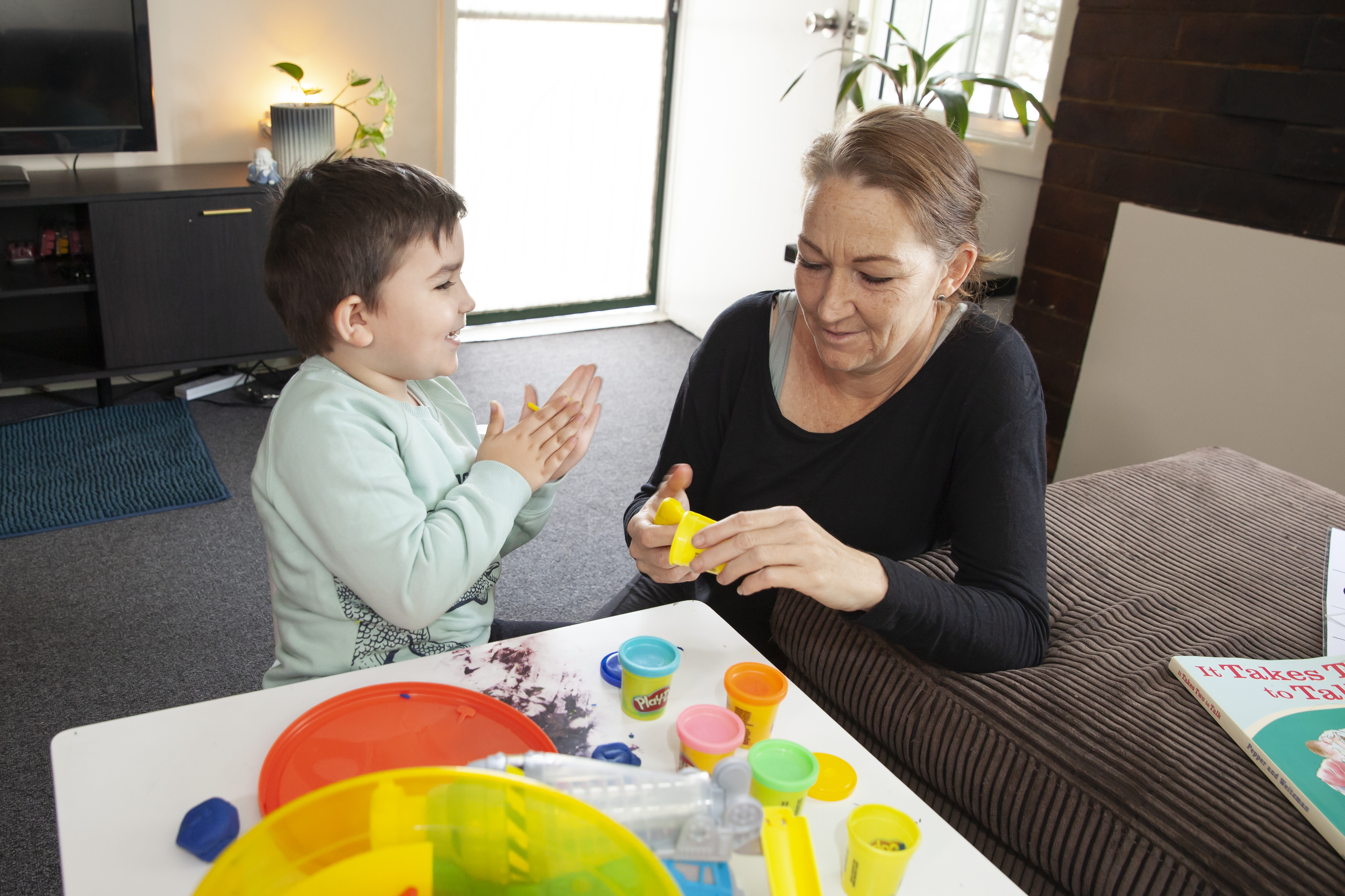 Young boy playing with play doh with Occupational Therapist