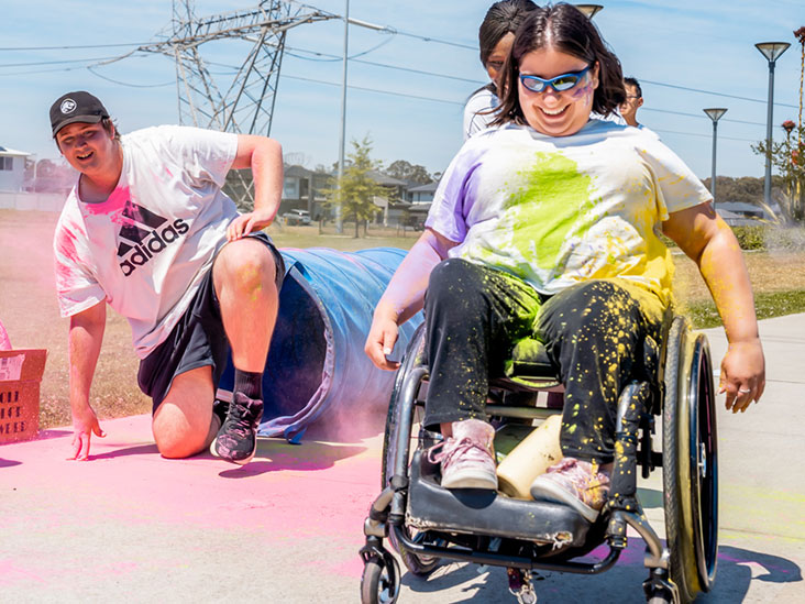 Woman in a wheelchair participating in the colour run