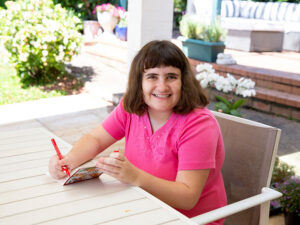 A young lady writing in a book