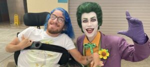 Customer in wheelchair and somebody dressed up as The Joker
