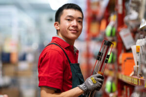 Male working at bunnings smiling at the camera