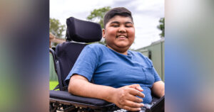 Young male smiling in a wheelchair