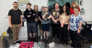 A group photo of young people with animals