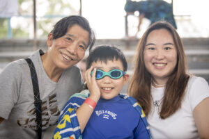 Child with his family outside of pool