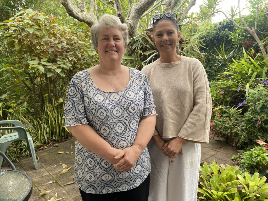 Two people standing in outdoor setting