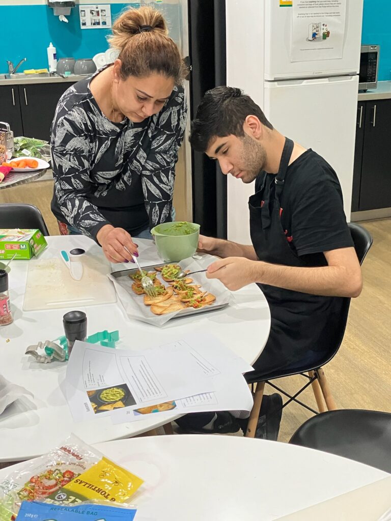 Boy making nachos with dietitian