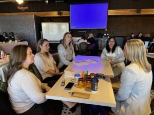 A group of people at a table talking.