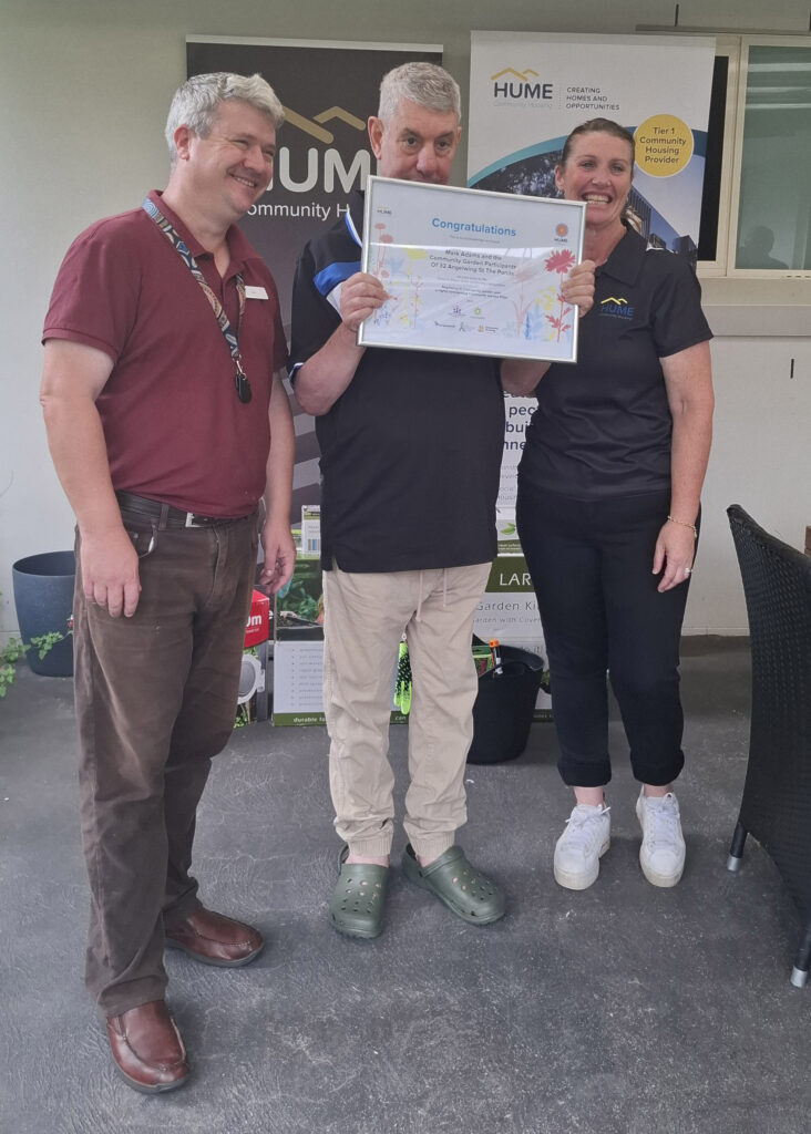 Mark holds a certificate proudly.