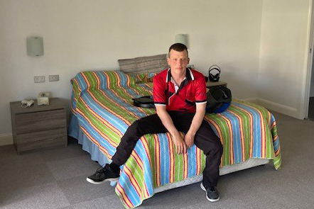 photo of Jock sitting on his bed