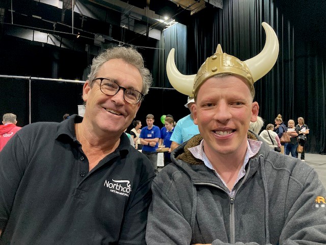 Jack is sitting next to a Northcott staff member. He is wearing a viking style hat with horns!