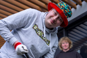 Stephen is smiling at the camera - he is wearing a colourful hat