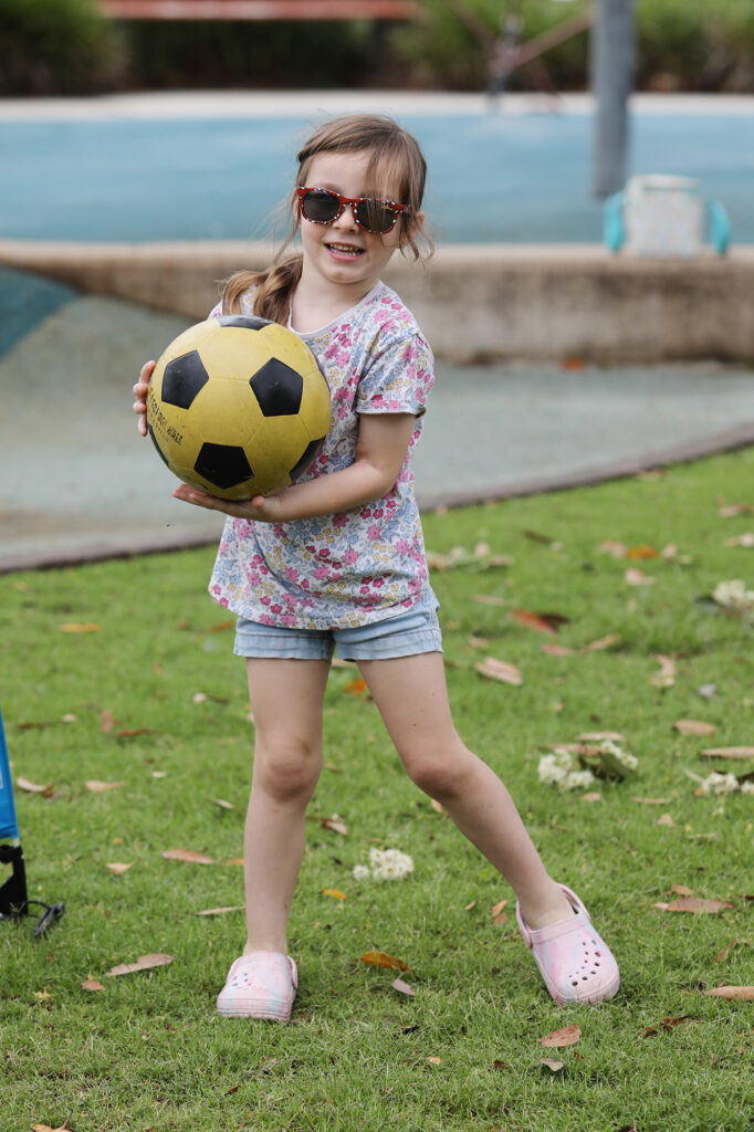 Edith playing with a soccer ball at Play Links supported playgroup.