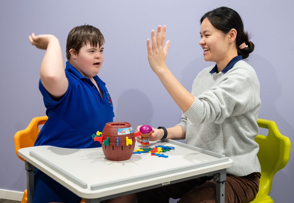 Ryker does a high five with his therapist